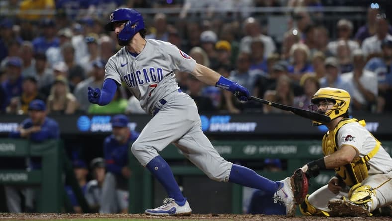 Jun 19, 2023; Pittsburgh, Pennsylvania, USA; Chicago Cubs shortstop Dansby Swanson (7) hits an infield RBI single against the Pittsburgh Pirates during the seventh inning at PNC Park. Mandatory Credit: Charles LeClaire-USA TODAY Sports