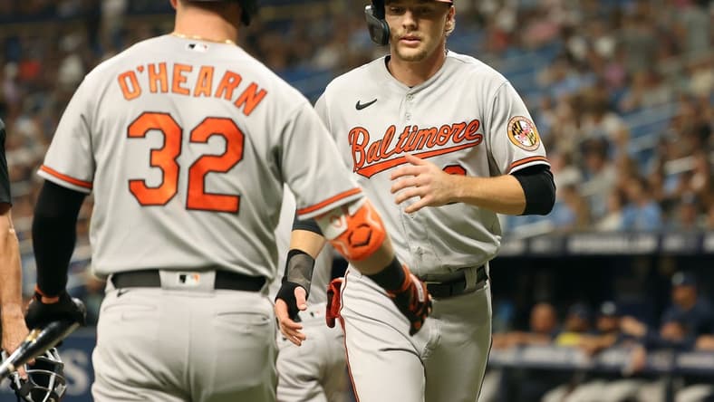 Jun 20, 2023; St. Petersburg, Florida, USA; Baltimore Orioles third baseman Gunnar Henderson (2) is congratulated by first baseman Ryan O'Hearn (32) after he scored a run against the Tampa Bay Rays during the first inning at Tropicana Field. Mandatory Credit: Kim Klement-USA TODAY Sports