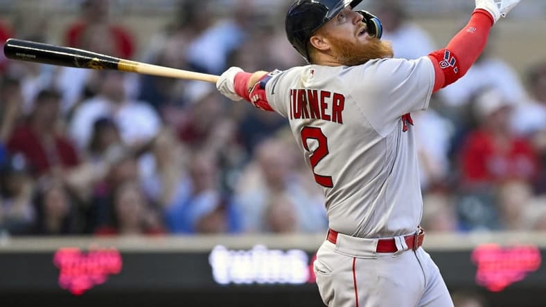 Jun 20, 2023; Minneapolis, Minnesota, USA; Boston Red Sox designated hitter Justin Turner (2) hits an RBI double against the Minnesota Twins during the seventh inning at Target Field. Mandatory Credit: Nick Wosika-USA TODAY Sports
