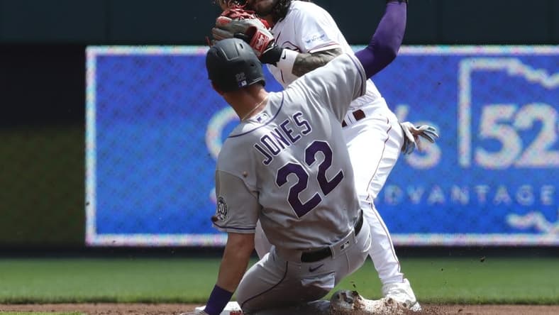 Jun 21, 2023; Cincinnati, Ohio, USA; Colorado Rockies first baseman Nolan Jones (22) is forced out at second against Cincinnati Reds second baseman Jonathan India (6) during the first inning at Great American Ball Park. Mandatory Credit: David Kohl-USA TODAY Sports