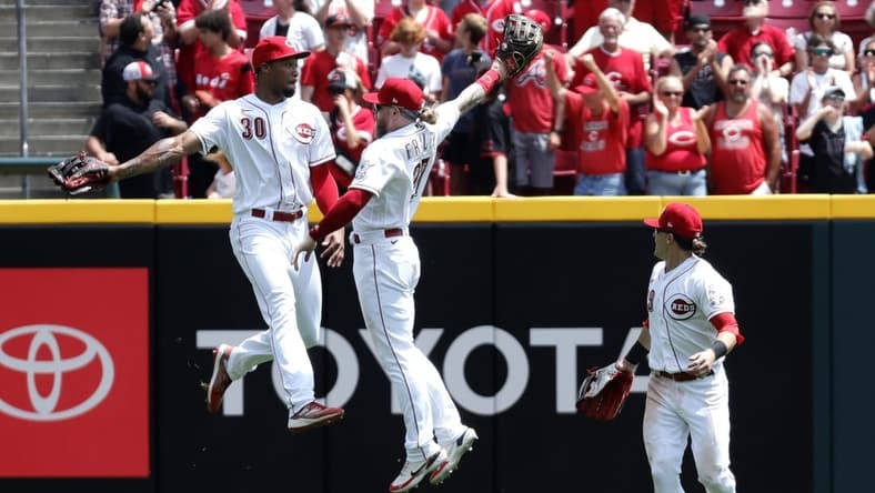 Jun 21, 2023; Cincinnati, Ohio, USA; Cincinnati Reds left fielder Will Benson (30) right fielder Jake Fraley (27) and center fielder TJ Friedl (29) celebrate after the Reds defeated the Colorado Rockies at Great American Ball Park. Mandatory Credit: David Kohl-USA TODAY Sports