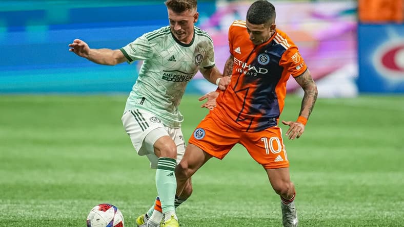 Jun 21, 2023; Atlanta, Georgia, USA; Atlanta United midfielder Amar Sejdic (13) and New York City midfielder Santiago Rodriguez (10) battle for the ball during the first half at Mercedes-Benz Stadium. Mandatory Credit: Dale Zanine-USA TODAY Sports