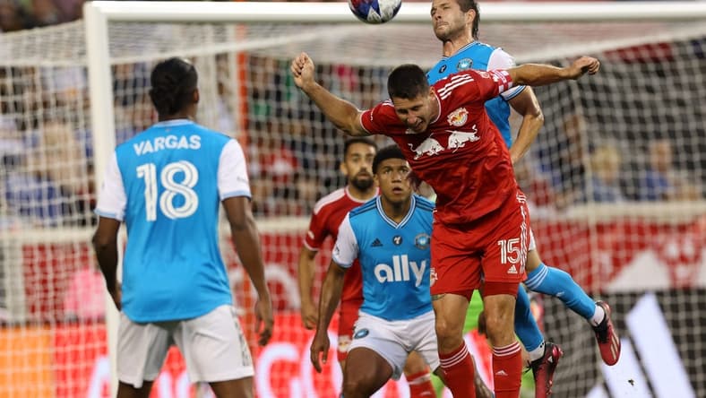 Jun 21, 2023; Harrison, New Jersey, USA; New York Red Bulls defender Sean Nealis (15) battles for header against Charlotte FC midfielder Brandt Bronico (13) during the first half at Red Bull Arena. Mandatory Credit: Vincent Carchietta-USA TODAY Sports