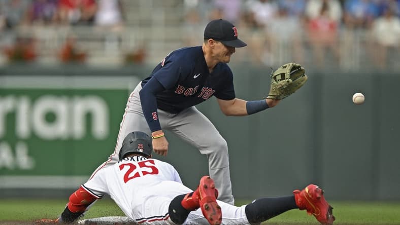 Jun 21, 2023; Minneapolis, Minnesota, USA; Minnesota Twins designated hitter Byron Buxton (25) beats the tag of Boston Red Sox infielder Enrique Hernandez (5) for a double during the second inning at Target Field. Mandatory Credit: Nick Wosika-USA TODAY Sports