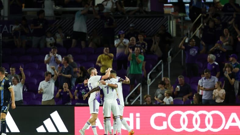 Jun 21, 2023; Orlando, Florida, USA;  Orlando City SC midfielder Martin Ojeda (11) is congratulated by forward Ivan Angulo (77) after scoring a goal against the Philadelphia Union in the second half at Exploria Stadium. Mandatory Credit: Nathan Ray Seebeck-USA TODAY Sports