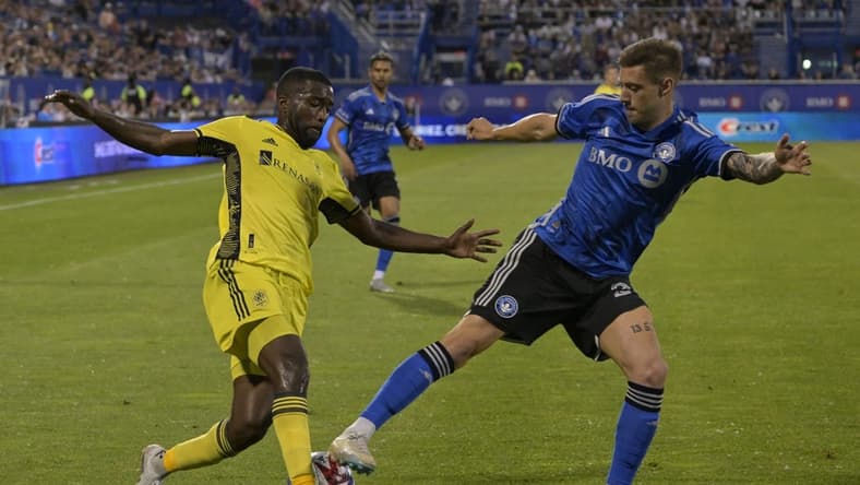 Jun 21, 2023; Montreal, Quebec, CAN;  Nashville SC defender Shaq Moore (18) battles for the ball against CF Montreal defender Gabriele Corbo (25) in the second half at Stade Saputo. Mandatory Credit: Eric Bolte-USA TODAY Sports
