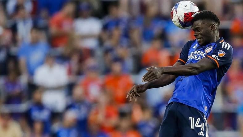 Jun 21, 2023; Cincinnati, Ohio, USA; FC Cincinnati forward Dominique Badji (14) heads the ball against Toronto FC in the second half at TQL Stadium. Mandatory Credit: Katie Stratman-USA TODAY Sports
