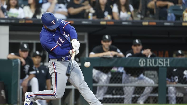 Jun 21, 2023; Chicago, Illinois, USA; Texas Rangers shortstop Ezequiel Duran (20) hits a two-run home run against the Chicago White Sox during the fourth inning at Guaranteed Rate Field. Mandatory Credit: Kamil Krzaczynski-USA TODAY Sports