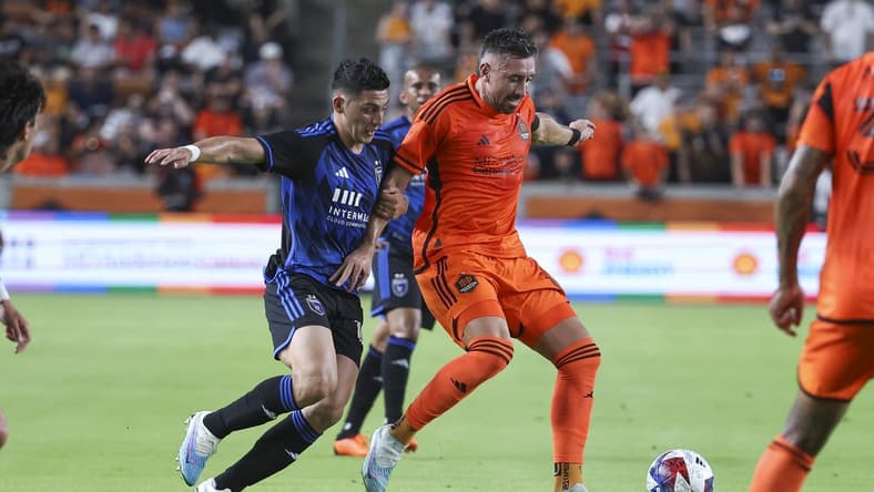 Jun 21, 2023; Houston, Texas, USA; Houston Dynamo FC midfielder Hector Herrera (16) attempts to control the ball as San Jose Earthquakes forward Cristian Espinoza (10) defends during the first half at Shell Energy Stadium. Mandatory Credit: Troy Taormina-USA TODAY Sports