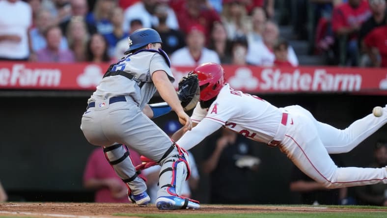 Jun 21, 2023; Anaheim, California, USA; Los Angeles Angels third baseman Luis Rengifo (2) is tagged out at home plate by Los Angeles Dodgers catcher Will Smith (16) in the third inning at Angel Stadium. Mandatory Credit: Kirby Lee-USA TODAY Sports