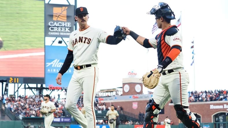 Jun 21, 2023; San Francisco, California, USA; San Francisco Giants relief pitcher Sean Hjelle (64) celebrates with catcher Black Sabol (2) after striking out a San Diego Padres batter during the fifth inning at Oracle Park. Mandatory Credit: Kelley L Cox-USA TODAY Sports