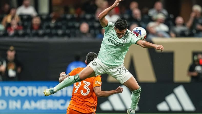 Jun 21, 2023; Atlanta, Georgia, USA; Atlanta United forward Tyler Wolff (28) plays the ball over top of New York City FC defender Tony Alfaro (93) during the second half at Mercedes-Benz Stadium. Mandatory Credit: Dale Zanine-USA TODAY Sports