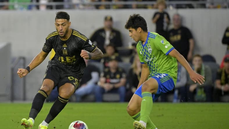 Jun 21, 2023; Los Angeles, California, USA; Los Angeles FC forward Denis Bouanga (99) dribbles the ball past Seattle Sounders midfielder Obed Vargas (73) during the first half at BMO Stadium. Mandatory Credit: Jayne Kamin-Oncea-USA TODAY Sports