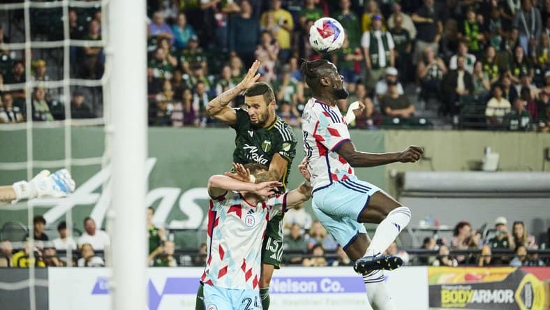 Jun 21, 2023; Portland, Oregon, USA; Chicago Fire forward Kei Kamara (23) heads the ball during the second half against Portland Timbers defender Dario Zuparic (13) at Providence Park. Mandatory Credit: Troy Wayrynen-USA TODAY Sports