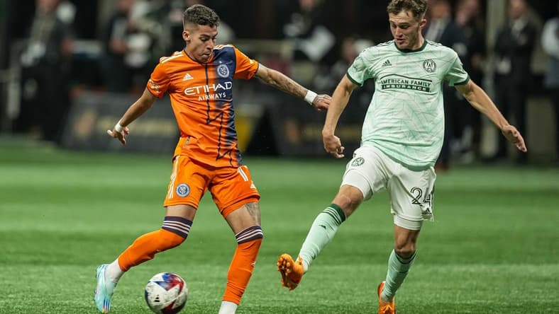 Jun 21, 2023; Atlanta, Georgia, USA; New York City FC midfielder Gabriel Pereira (11) kicks the ball against Atlanta United defender Noah Cobb (24) during the first half at Mercedes-Benz Stadium. Mandatory Credit: Dale Zanine-USA TODAY Sports