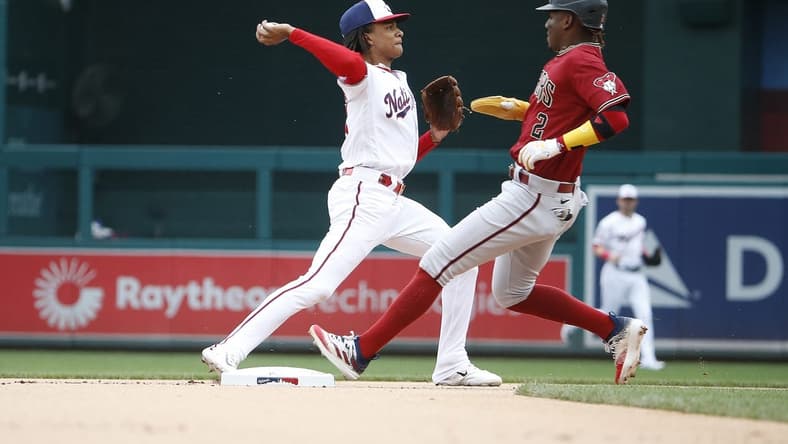 Jun 22, 2023; Washington, District of Columbia, USA; Washington Nationals shortstop CJ Abrams (5) tags out Arizona Diamondbacks shortstop Geraldo Perdomo (2) on second base and throws the ball to first during the first inning at Nationals Park. Mandatory Credit: Amber Searls-USA TODAY Sports