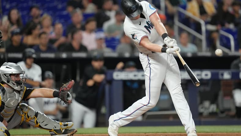 Jun 22, 2023; Miami, Florida, USA;  Miami Marlins first baseman Garrett Cooper (26) hits a double in the second inning against the Pittsburgh Pirates at loanDepot Park. Mandatory Credit: Jim Rassol-USA TODAY Sports