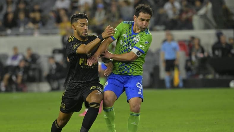 Jun 21, 2023; Los Angeles, California, USA; (EDITORS NOTE: Caption correction) Seattle Sounders midfielder Nicolas Lodeiro (9) fights for the ball against Los Angeles FC forward Denis Bouanga (99) during the game at BMO Stadium. Mandatory Credit: Jayne Kamin-Oncea-USA TODAY Sports