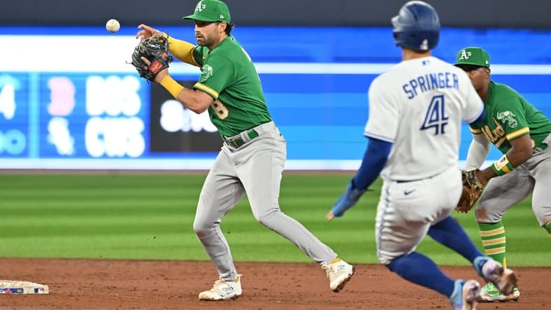 Jun 23, 2023; Toronto, Ontario, CAN; Oakland Athletics shortstop Tyler Wade (8) loses the ball after forcing out Toronto Blue Jays right fielder George Springer (4) at second base in the third inning at Rogers Centre. Mandatory Credit: Dan Hamilton-USA TODAY Sports