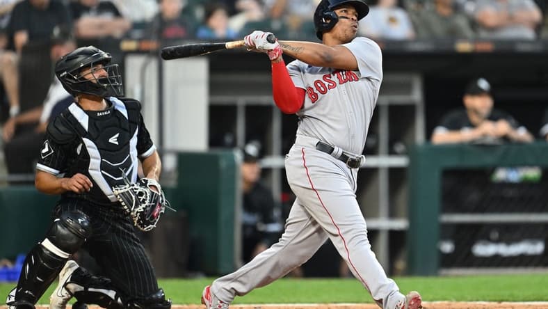 Jun 23, 2023; Chicago, Illinois, USA; Boston Red Sox infielder Rafael Devers (11) hits a two-run home run in the fourth inning against the Chicago White Sox at Guaranteed Rate Field. Mandatory Credit: Jamie Sabau-USA TODAY Sports