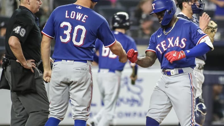 Jun 23, 2023; Bronx, New York, USA; Texas Rangers right fielder Adolis Garcia (53) celebrates with first baseman Nathaniel Lowe (30) after hitting a two run home run in the tenth inning against the New York Yankees at Yankee Stadium. Mandatory Credit: Wendell Cruz-USA TODAY Sports
