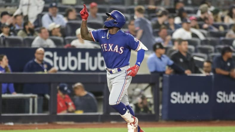 Jun 23, 2023; Bronx, New York, USA; Texas Rangers right fielder Adolis Garcia (53) gestures after hitting a two run home run in the tenth inning against the New York Yankees at Yankee Stadium. Mandatory Credit: Wendell Cruz-USA TODAY Sports