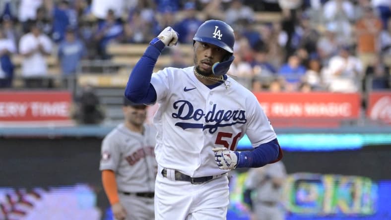 Jun 23, 2023; Los Angeles, California, USA; Los Angeles Dodgers right fielder Mookie Betts (50) pumps his fist as he rounds the bases after hitting a solo home run in the first inning against the Houston Astros at Dodger Stadium. Mandatory Credit: Jayne Kamin-Oncea-USA TODAY Sports