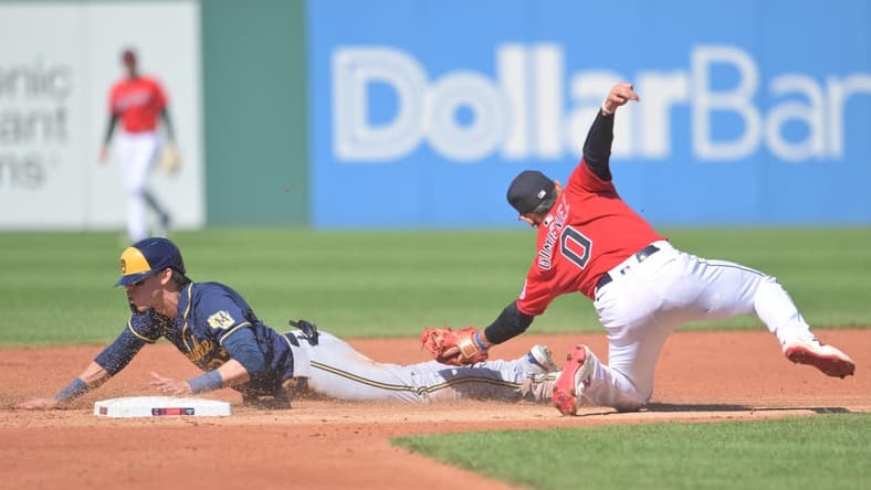 Jun 24, 2023; Cleveland, Ohio, USA; Milwaukee Brewers left fielder Christian Yelich (22) steals second as Cleveland Guardians second baseman Andres Gimenez (0) is late with the tag during the third inning at Progressive Field. Mandatory Credit: Ken Blaze-USA TODAY Sports