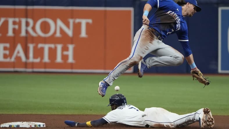 Jun 24, 2023; St. Petersburg, Florida, USA; Tampa Bay Rays right fielder Vidal Brujan (7) steals second base as Kansas City Royals shortstop Bobby Witt Jr. (7) fails to make the catch and tag during the fourth inning at Tropicana Field. Mandatory Credit: Dave Nelson-USA TODAY Sports