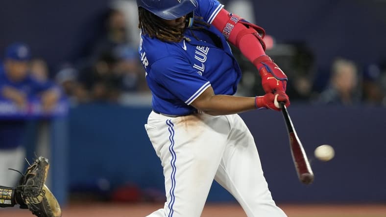 Jun 24, 2023; Toronto, Ontario, CAN; Toronto Blue Jays first baseman Vladimir Guerrero Jr. (27) hits a two run home run against the Oakland Athletics during the sixth inning at Rogers Centre. Mandatory Credit: John E. Sokolowski-USA TODAY Sports
