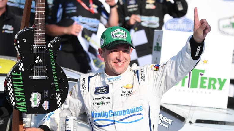 Jun 24, 2023; Nashville, Tennessee, USA; NASCAR Xfinity Series driver AJ Allmendinger (10) and his team celebrate winning the Tennessee Lottery 250 at Nashville Superspeedway. Mandatory Credit: Christopher Hanewinckel-USA TODAY Sports