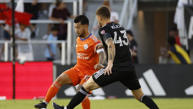 Jun 24, 2023; Washington, District of Columbia, USA; FC Cincinnati midfielder Luciano Acosta (10) dribbles the ball as D.C. United midfielder Mateusz Klich (43) defends. in the first half at Audi Field. Mandatory Credit: Geoff Burke-USA TODAY Sports