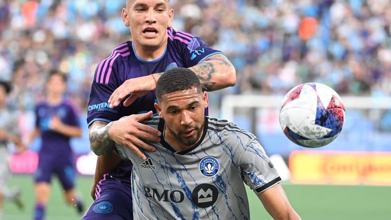 Jun 24, 2023; Charlotte, North Carolina, USA;  Charlotte FC forward Enzo Copetti (9) and CF Montr  al defender George Campbell (24) fight for the ball in the first half at Bank of America Stadium. Mandatory Credit: Bob Donnan-USA TODAY Sports