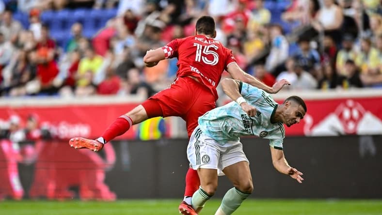 Jun 24, 2023; Harrison, New Jersey, USA; New York Red Bulls defender Sean Nealis (15) battles Atlanta United forward Giorgos Giakoumakis (7) during the first half at Red Bull Arena. Mandatory Credit: John Jones-USA TODAY Sports