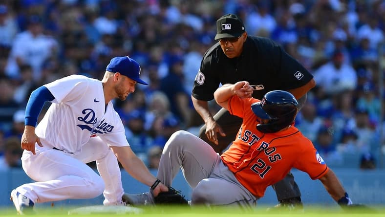 Jun 24, 2023; Los Angeles, California, USA; Houston Astros catcher Yainer Diaz (21) is out at third against the tag of Los Angeles Dodgers third baseman Michael Busch (83) during the fourth inning at Dodger Stadium. Mandatory Credit: Gary A. Vasquez-USA TODAY Sports