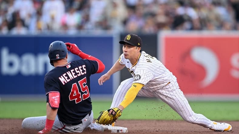 Jun 24, 2023; San Diego, California, USA; San Diego Padres second baseman Ha-seong Kim (right) tags out Washington Nationals designated hitter Joey Meneses (45) at second base during the sixth inning at Petco Park. Mandatory Credit: Orlando Ramirez-USA TODAY Sports