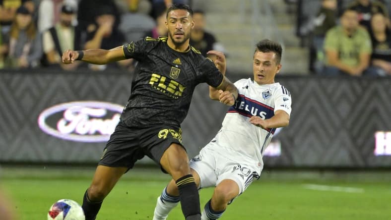 Jun 24, 2023; Los Angeles, California, USA; Los Angeles FC forward Denis Bouanga (99) and Vancouver Whitecaps midfielder Andres Cubas (20) go for the ball in the first half at BMO Stadium. Mandatory Credit: Jayne Kamin-Oncea-USA TODAY Sports