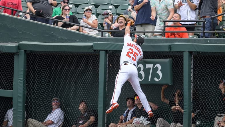 Jun 25, 2023; Baltimore, Maryland, USA; Baltimore Orioles right fielder Anthony Santander (25) makes a catch at the wall during the first inning against the Seattle Mariners at Oriole Park at Camden Yards. Mandatory Credit: Reggie Hildred-USA TODAY Sports
