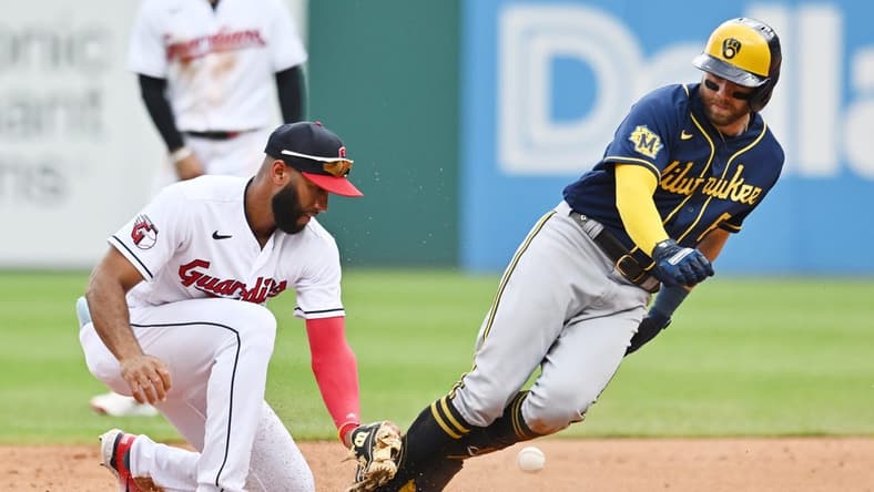 Jun 25, 2023; Cleveland, Ohio, USA; Milwaukee Brewers third baseman Owen Miller (6) is safe at second with an RBI double as Cleveland Guardians shortstop Amed Rosario (1) can not handle the throw during the third inning at Progressive Field. Mandatory Credit: Ken Blaze-USA TODAY Sports