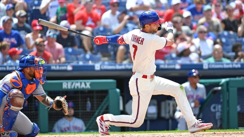 Jun 25, 2023; Philadelphia, Pennsylvania, USA; Philadelphia Phillies shortstop Trea Turner (7) hits an RBI single against the New York Mets during the third inning at Citizens Bank Park. Mandatory Credit: Eric Hartline-USA TODAY Sports