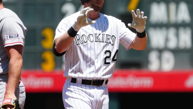Jun 25, 2023; Denver, Colorado, USA; Colorado Rockies third baseman Ryan McMahon (24) reacts to his single in the first inning against the Los Angeles Angels at Coors Field. Mandatory Credit: Ron Chenoy-USA TODAY Sports