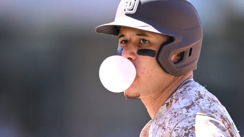 Jun 25, 2023; San Diego, California, USA; San Diego Padres third baseman Manny Machado (13) blows a bubble-gum bubble during the sixth inning against the Washington Nationals at Petco Park. Mandatory Credit: Orlando Ramirez-USA TODAY Sports