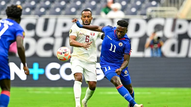 Jun 25, 2023; Houston, Texas, USA; Haiti forward Derrick Etienne (11) and Qatar midfielder Ahmed Abdoulla (6) battle for possession during the first half at NRG Stadium. Mandatory Credit: Maria Lysaker-USA TODAY Sports