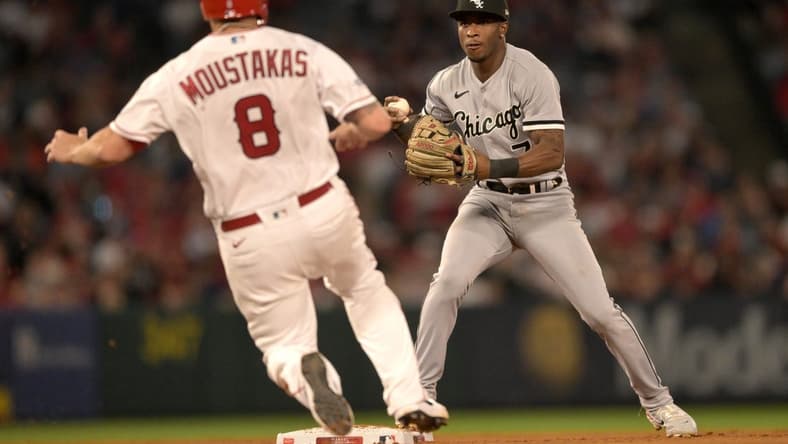 Jun 26, 2023; Anaheim, California, USA;  Los Angeles Angels first baseman Mike Moustakas (8) is out at second as Chicago White Sox shortstop Tim Anderson (7) throws to first for a double play in the seventh inning at Angel Stadium. Mandatory Credit: Jayne Kamin-Oncea-USA TODAY Sports