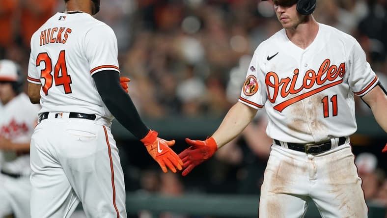 Jun 26, 2023; Baltimore, Maryland, USA; Baltimore Orioles outfielder Aaron Hicks (34) greeted by second baseman Jordan Westburg (11) after scoring a run in the sixth inning against the Cincinnati Reds at Oriole Park at Camden Yards. Mandatory Credit: Mitch Stringer-USA TODAY Sports