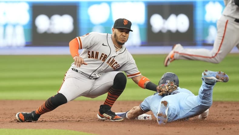 Jun 27, 2023; Toronto, Ontario, CAN; San Francisco Giants second baseman Thairo Estrada (39) catches Toronto Blue Jays left fielder Whit Merrifield (15) trying to steal second base during the second inning at Rogers Centre. Mandatory Credit: John E. Sokolowski-USA TODAY Sports