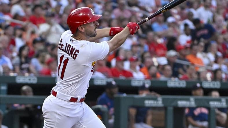 Jun 27, 2023; St. Louis, Missouri, USA;  St. Louis Cardinals shortstop Paul DeJong (11) hits a one run sacrifice fly against the Houston Astros during the fourth inning at Busch Stadium. Mandatory Credit: Jeff Curry-USA TODAY Sports