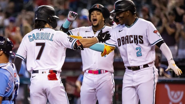 Jun 27, 2023; Phoenix, Arizona, USA; Arizona Diamondbacks outfielder Corbin Carroll (7) celebrates with teammates Geraldo Perdomo (2) and Ketel Marte after hitting a three run home run in the first inning against the Tampa Bay Rays at Chase Field. Mandatory Credit: Mark J. Rebilas-USA TODAY Sports