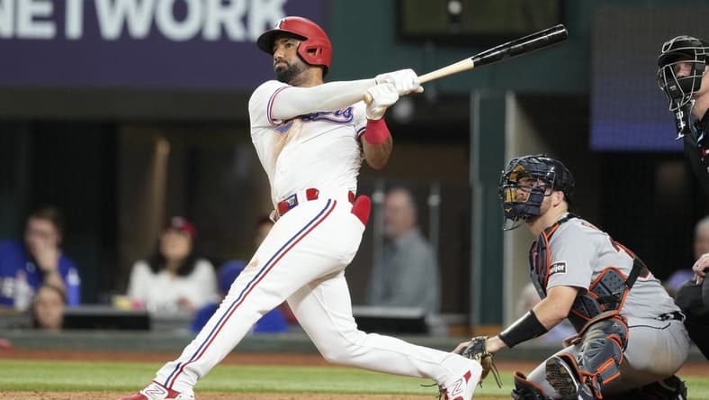 Jun 27, 2023; Arlington, Texas, USA; Texas Rangers left fielder Ezequiel Duran (20) follows through on his home run against the Detroit Tigers during the eighth inning at Globe Life Field. Mandatory Credit: Jim Cowsert-USA TODAY Sports