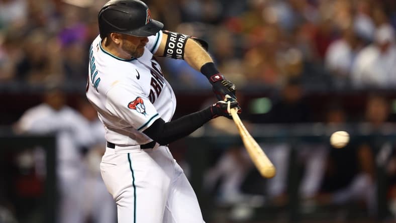 Jun 27, 2023; Phoenix, Arizona, USA; Arizona Diamondbacks infielder Evan Longoria hits a solo home run in the third inning against the Tampa Bay Rays at Chase Field. Mandatory Credit: Mark J. Rebilas-USA TODAY Sports